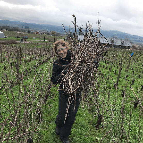 Sarah Martin in the vineyard with vine cuttings